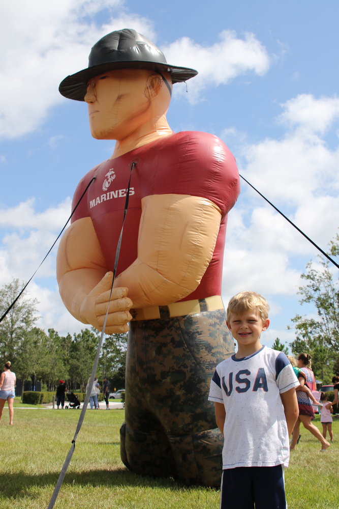Michael Drosdick stands next to the huge inflatable marine at the July 20 Nocatee Farmers Market. Michael will be a first grader at Ocean Palms when summer ends.